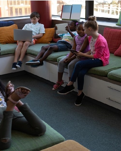 children-reading-with-friends-at-library