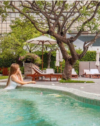 woman-in-pool-at-luxury-hotel