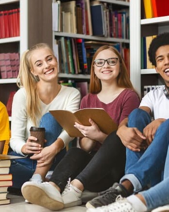 diverse-students-sitting-in-library