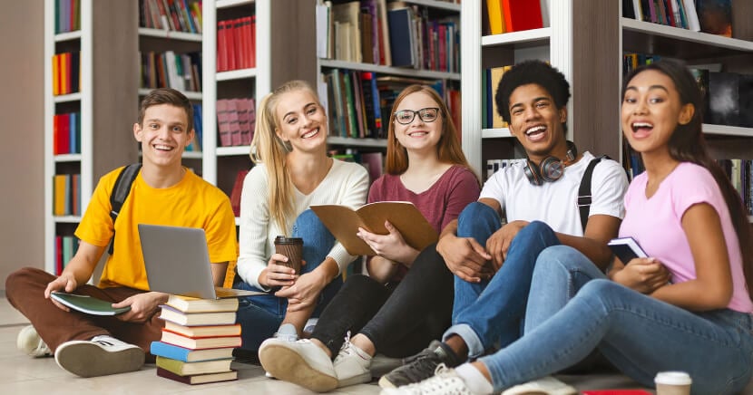 diverse-students-sitting-in-library