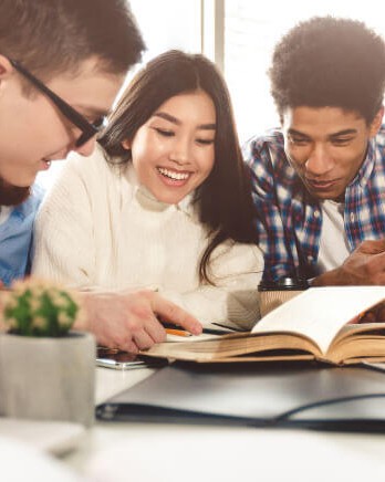 Diverse-Student-Group-Studying-At-Library