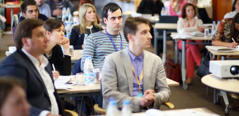 Group-of-people-listening-to-a-speaker