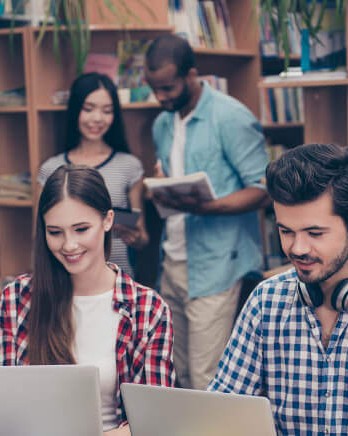 happy-students-in-busy-library
