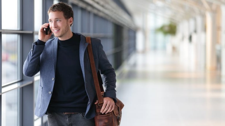 Casual-Business-Traveller-on-Call-at-Airport