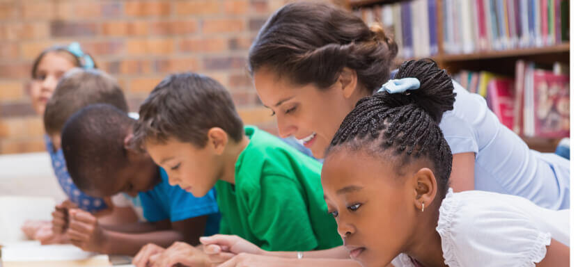 Cute-Pupils-Reading-on-Library-Floor