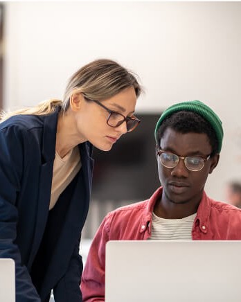 students-in-library-looking-at-desktop-internet