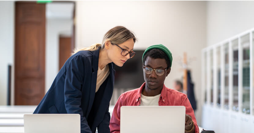 students-in-library-looking-at-desktop-internet