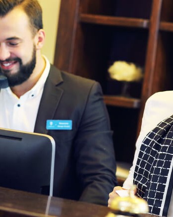 two-hotel-receptionists-at-desk